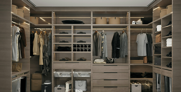 Modern walk-in closet with wooden shelves, drawers, and hanging clothes.