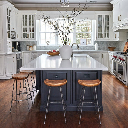 Kitchen Reset - Alyssa Lane: 
Modern kitchen with a central island, bar stools, and stainless steel appliances.