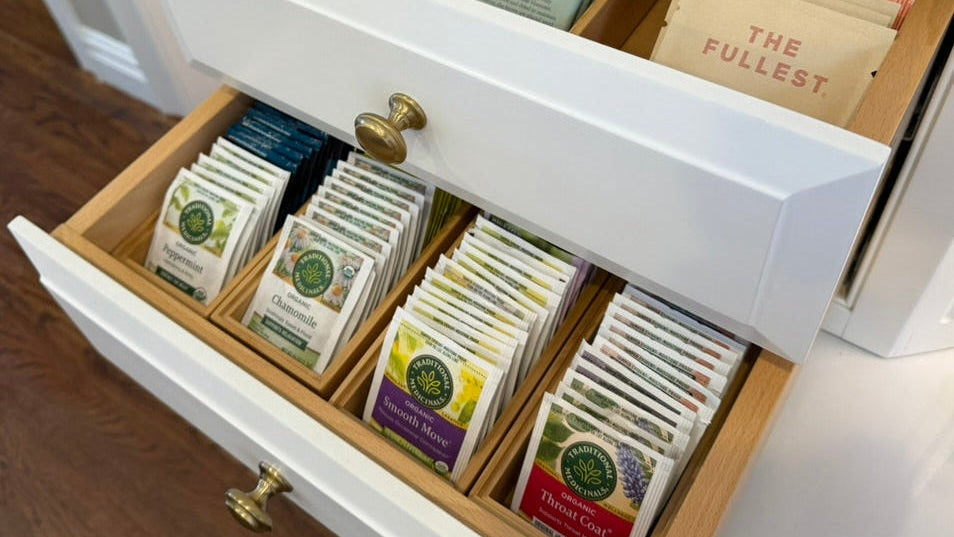 Open drawer with various tea bags labeled 'The Fullest' and others.